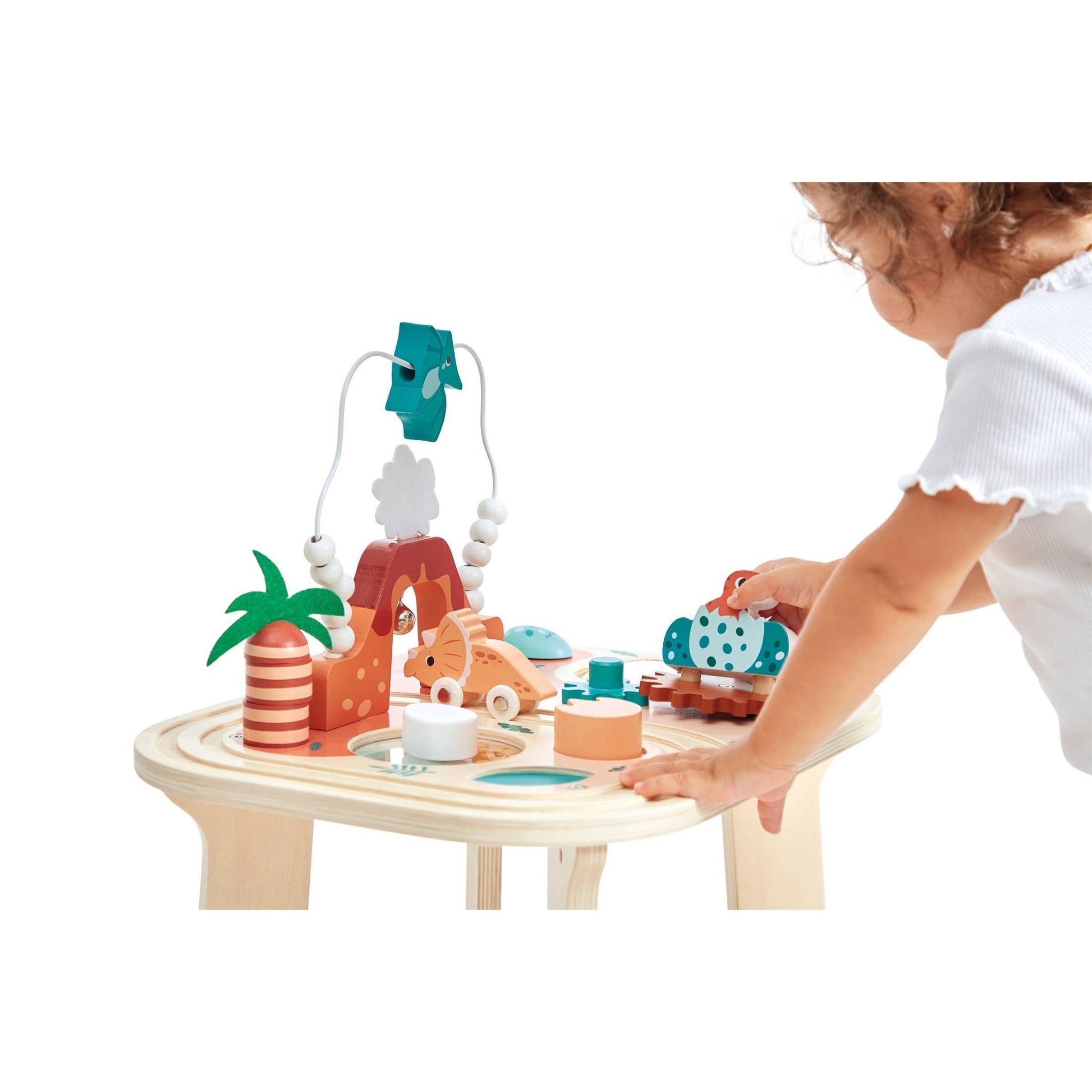 Child playing with a wooden toy set on a table