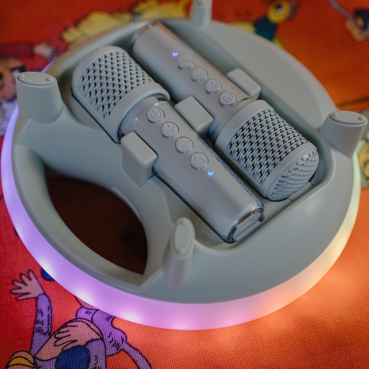 Gray electronic device with two microphones on a colorful background