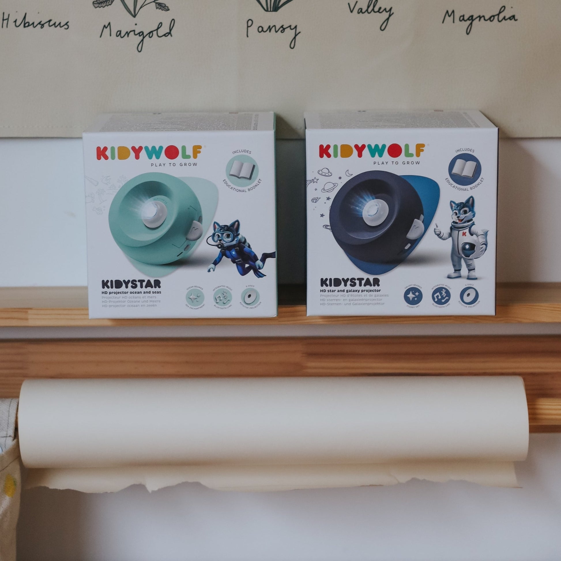 Two 'KIDYWOLF' product boxes on a shelf with a roll of paper in the foreground.