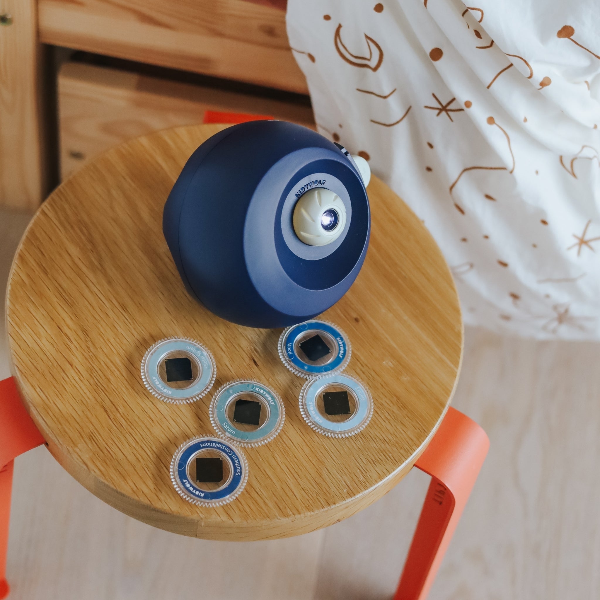 Blue and white container with black lids on a wooden stool