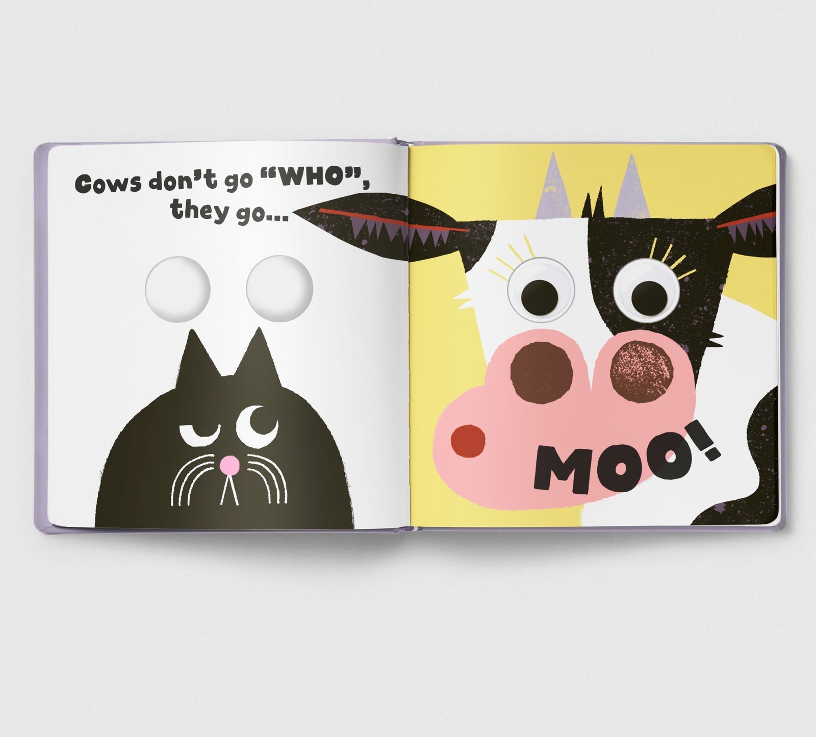 Open book with cartoon cow and cat illustration on a white background