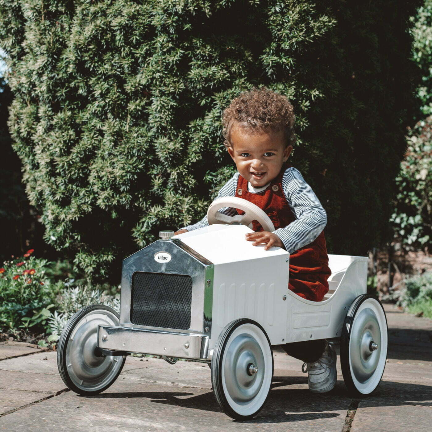 Child playing with a toy car outdoors
