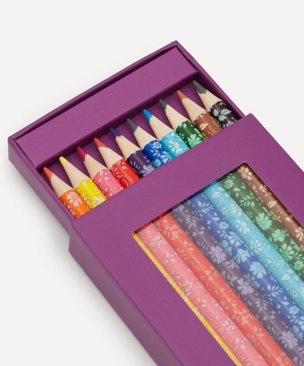 Set of colorful patterned pencils in a purple box on a white background
