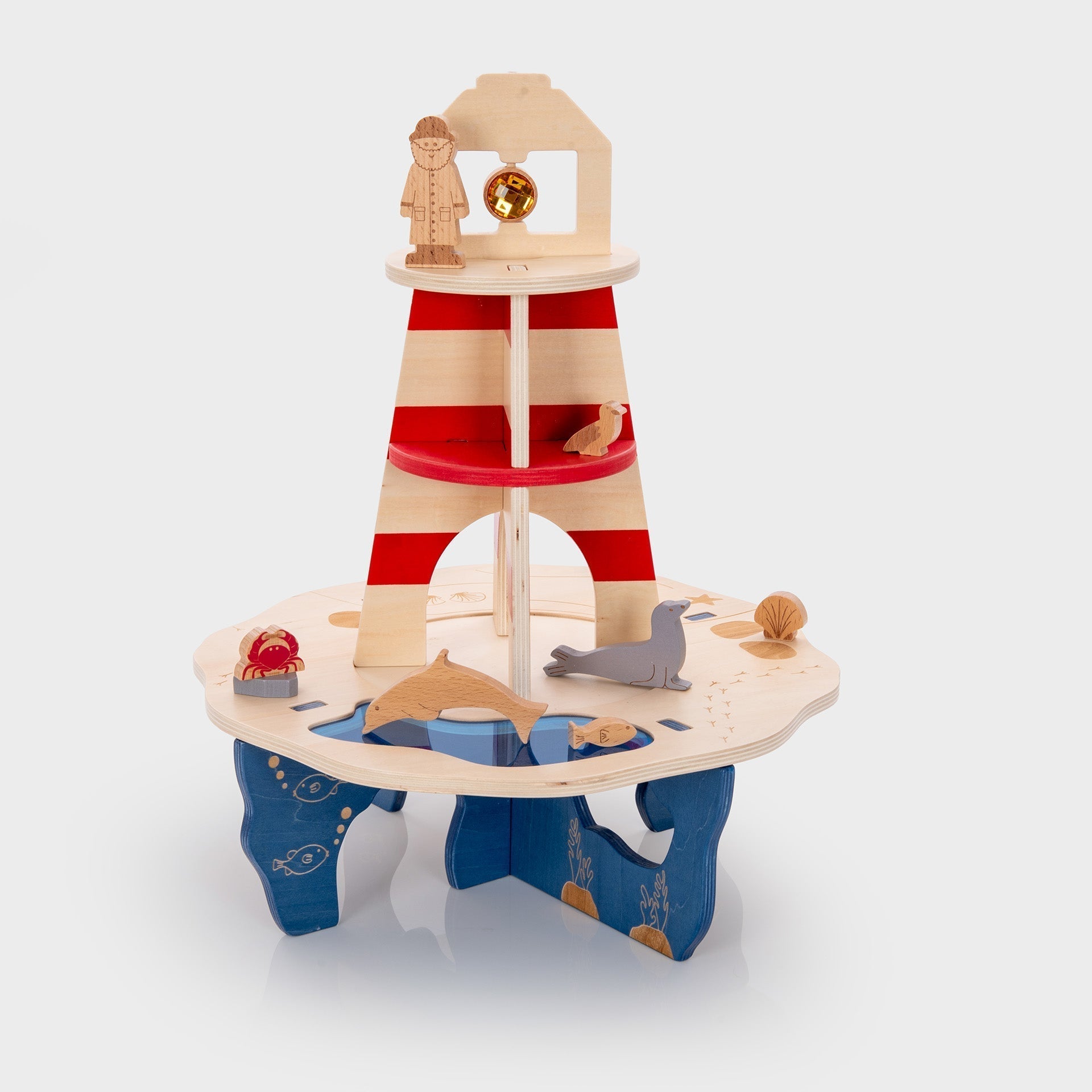 Wooden toy lighthouse with striped design on a white background