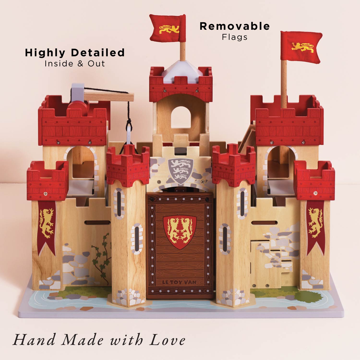 Wooden toy castle with red flags and detailed design on a light background
