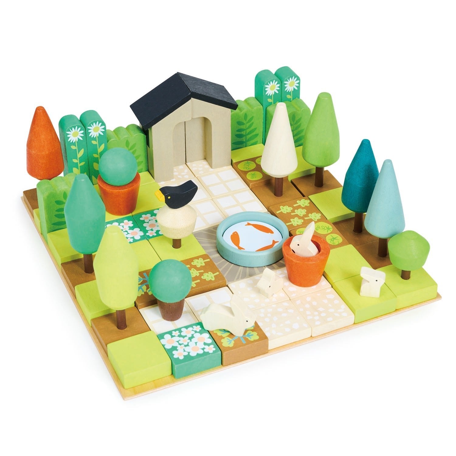 Toy garden set with trees, house, and animals on a white background