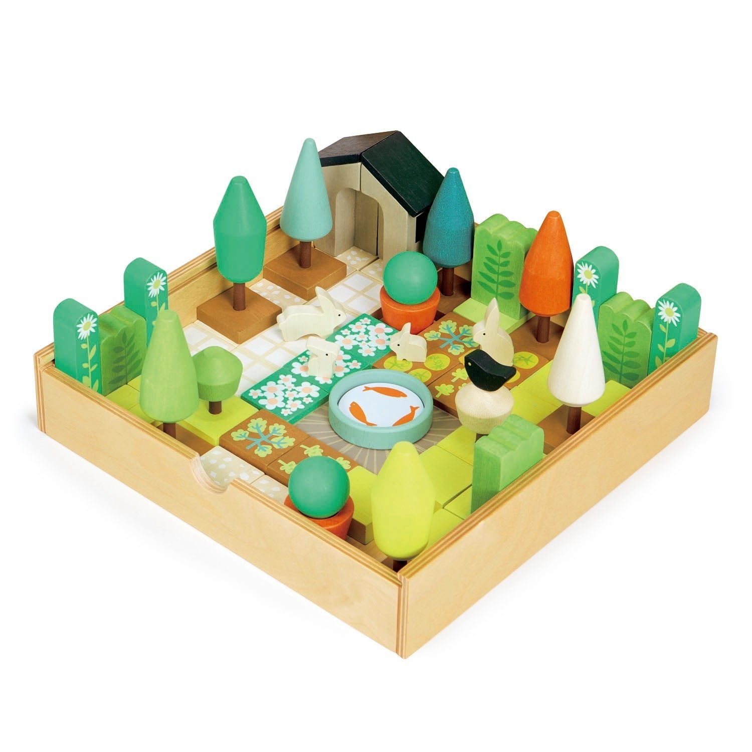 Wooden toy set with trees, animals, and a cabin on a white background