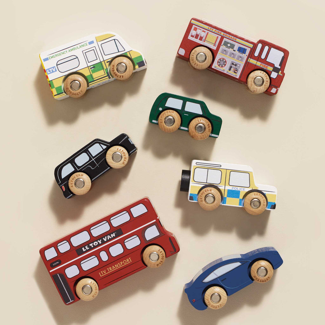Set of colorful toy cars on a beige background