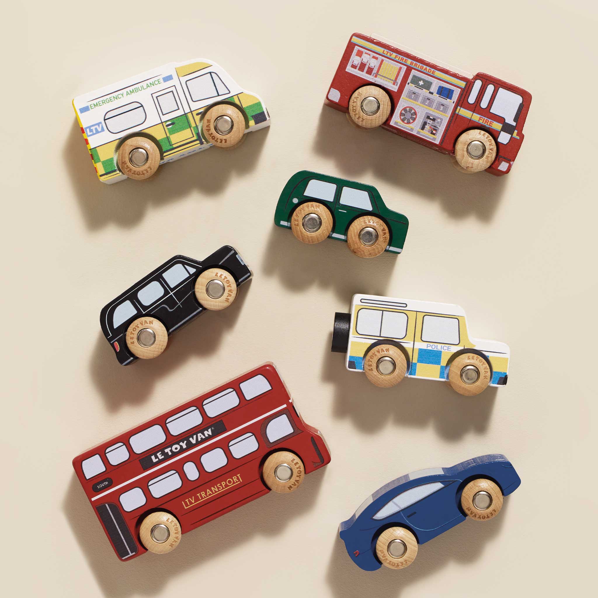 Set of colorful toy cars on a beige background