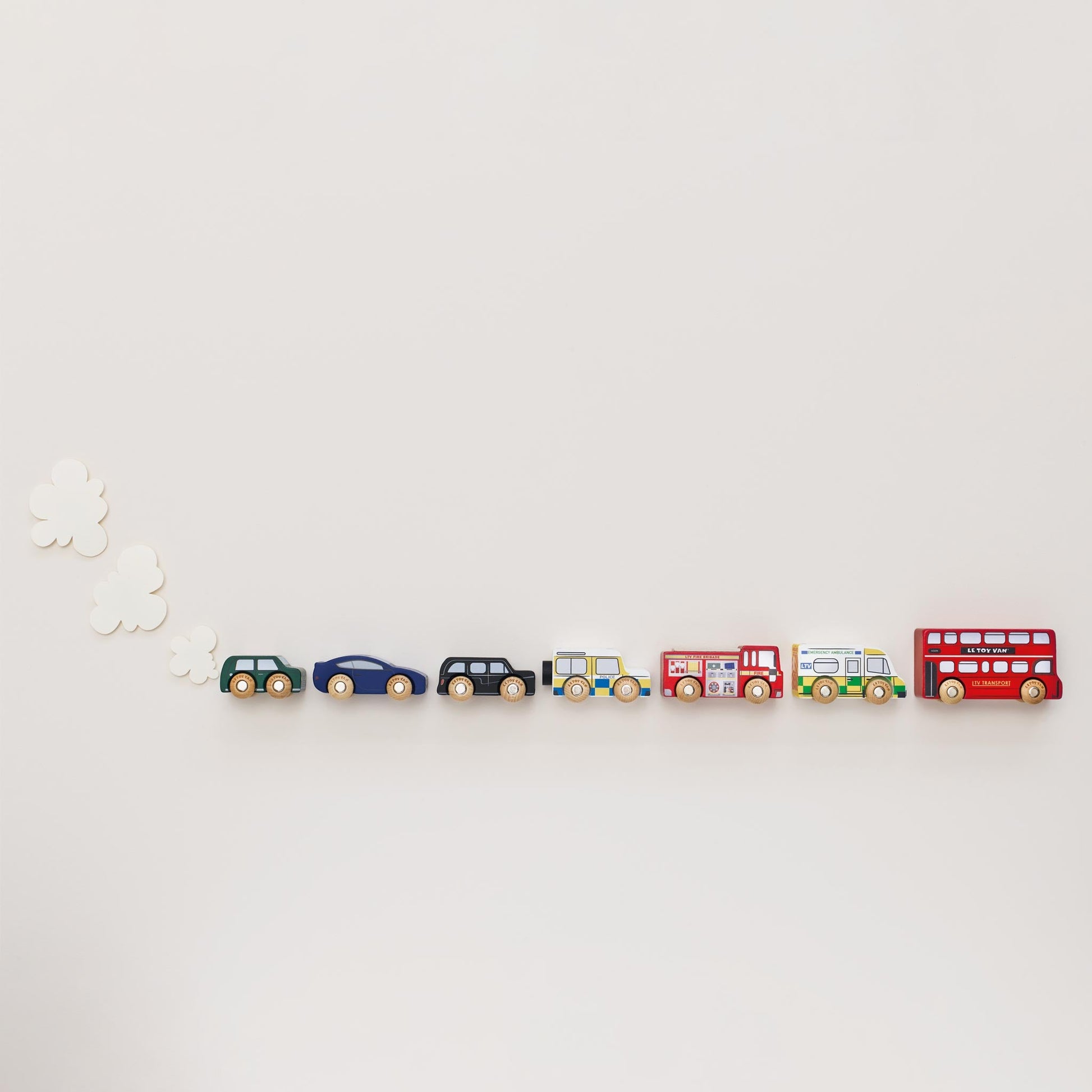 Set of toy cars and a bus on a white background
