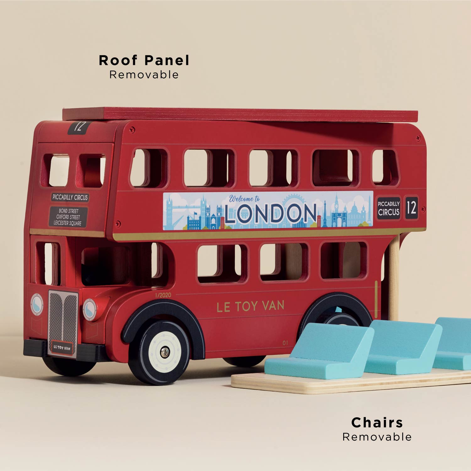 Red toy bus with removable roof panel and chairs on a beige background, featuring Le Toy Van branding.