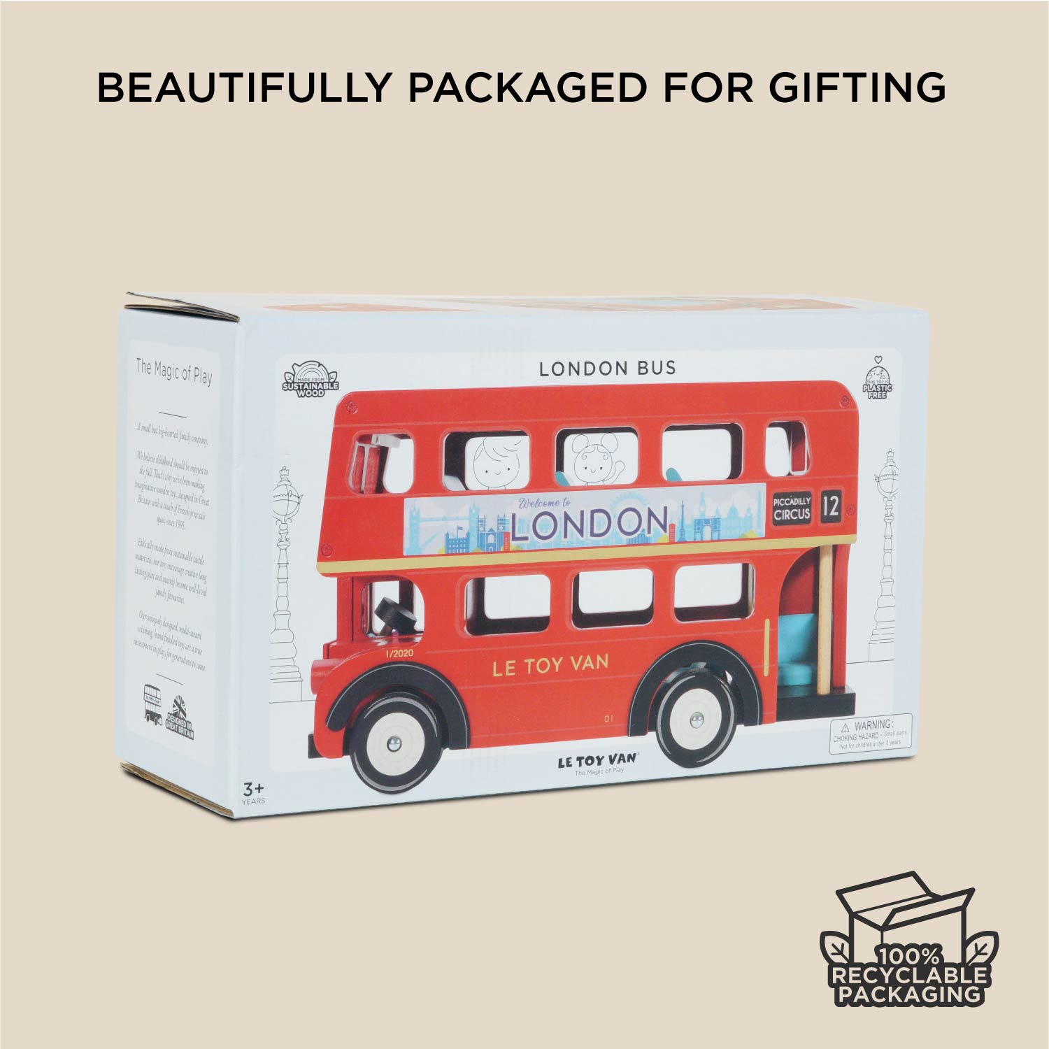 Boxed toy London bus with branding and recycling information on a beige background