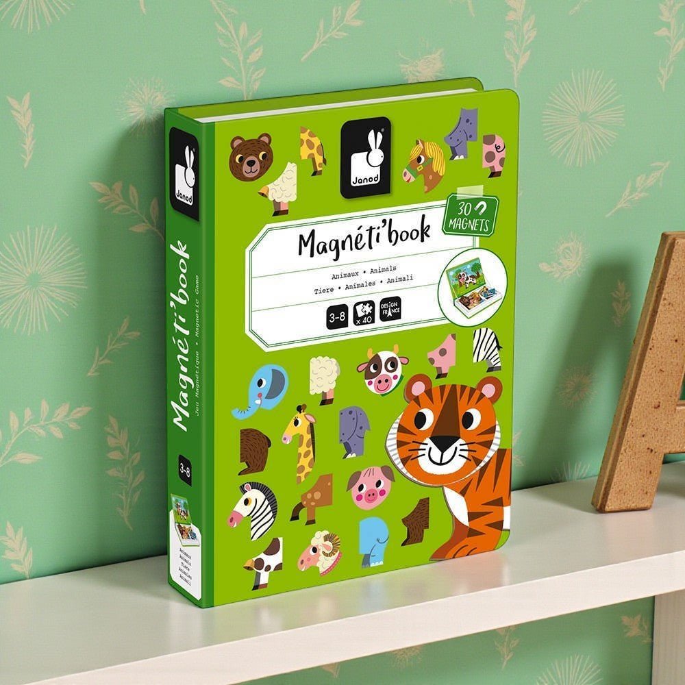 Green children's book with animal illustrations on a shelf against a green wall with floral patterns.
