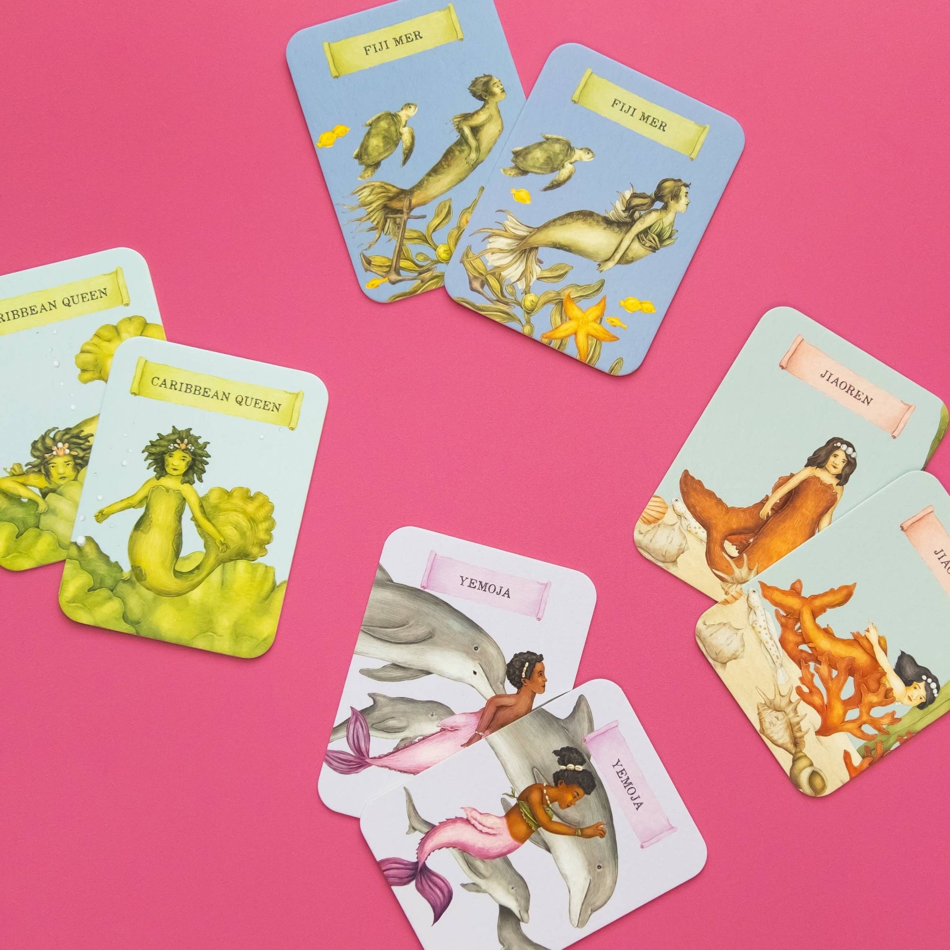 Set of tarot cards featuring mermaids and dolphins on a pink background