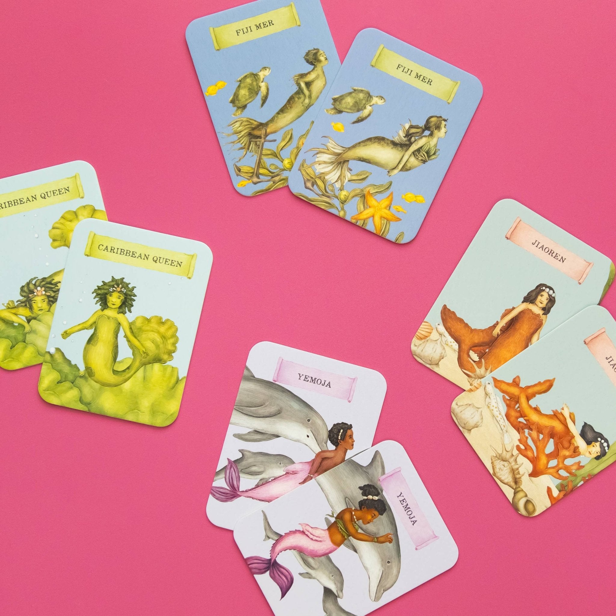 Set of tarot cards featuring mermaids and dolphins on a pink background
