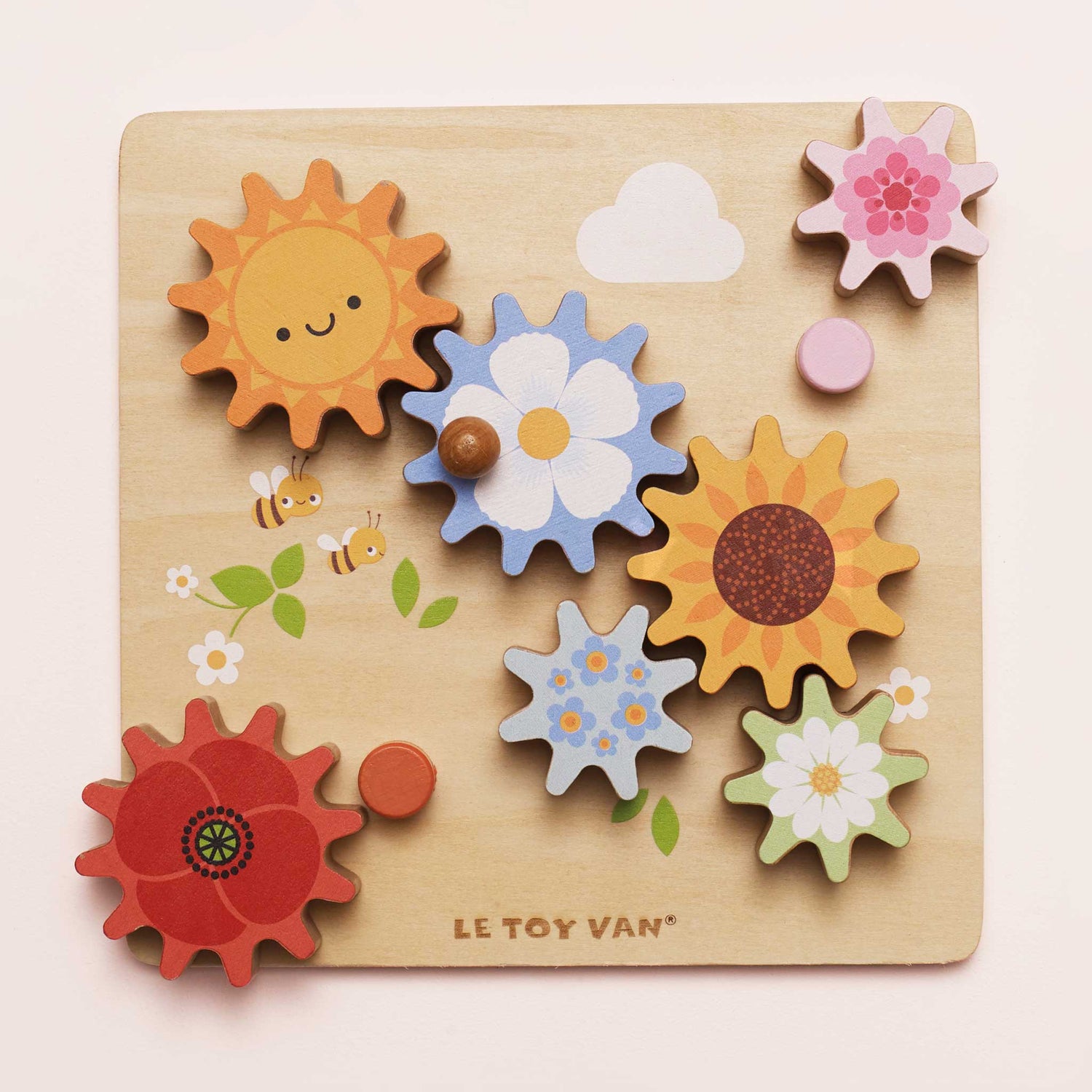 Wooden puzzle with colorful flowers and sun shapes on a light pink background, featuring the brand 'Le Toy Van'.