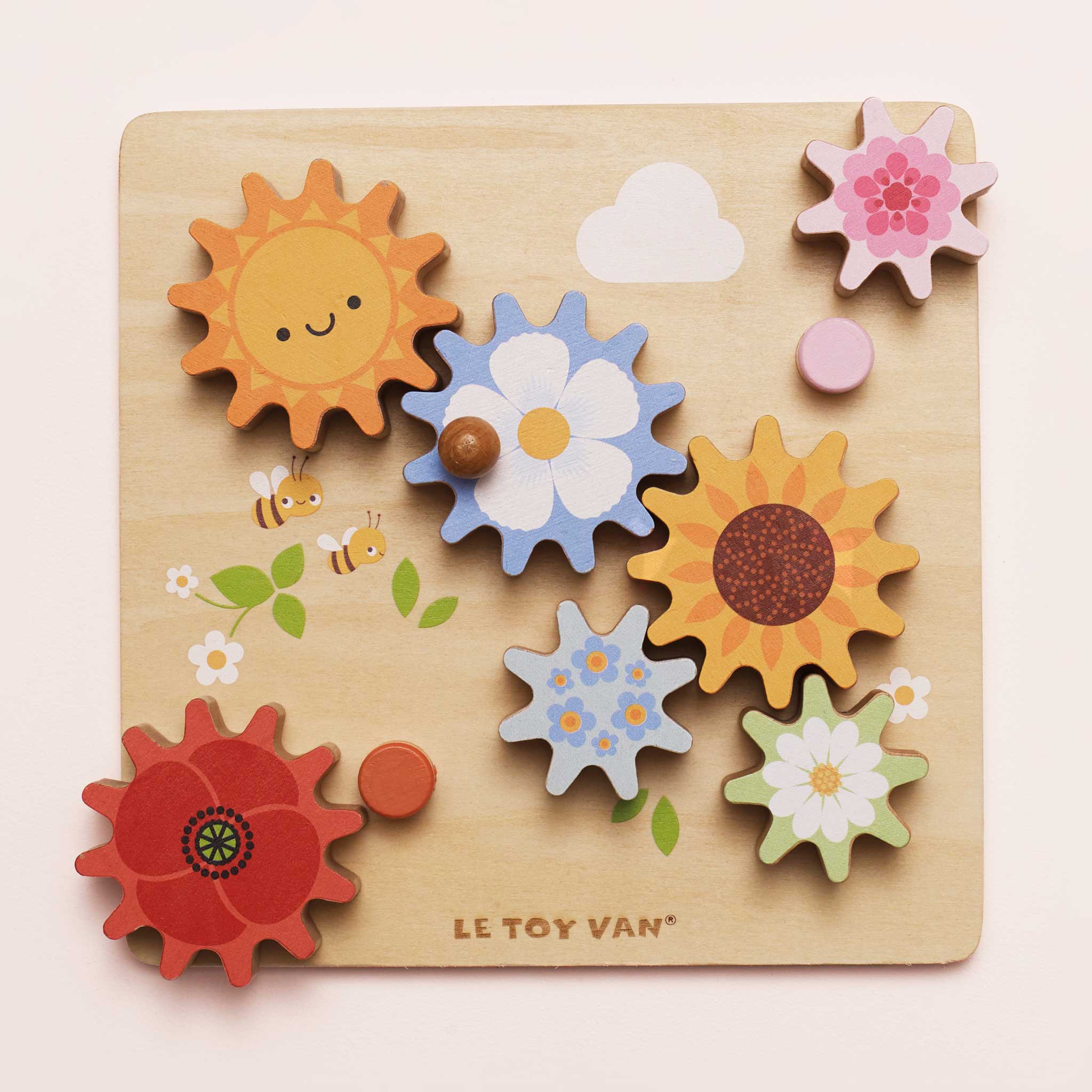 Wooden puzzle with colorful flowers and sun shapes on a light pink background, featuring the brand 'Le Toy Van'.
