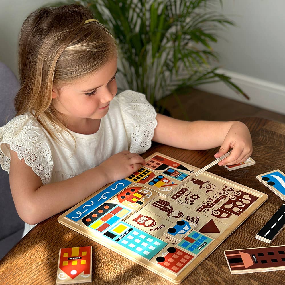 Young girl playing with a wooden puzzle on a table.