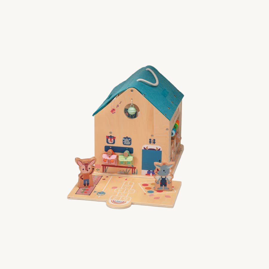 Toy house with two small figures on a white background
