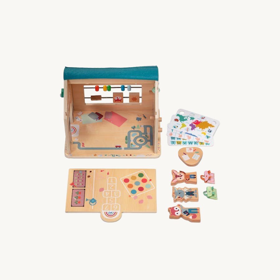 Wooden toy set with various pieces on a white background