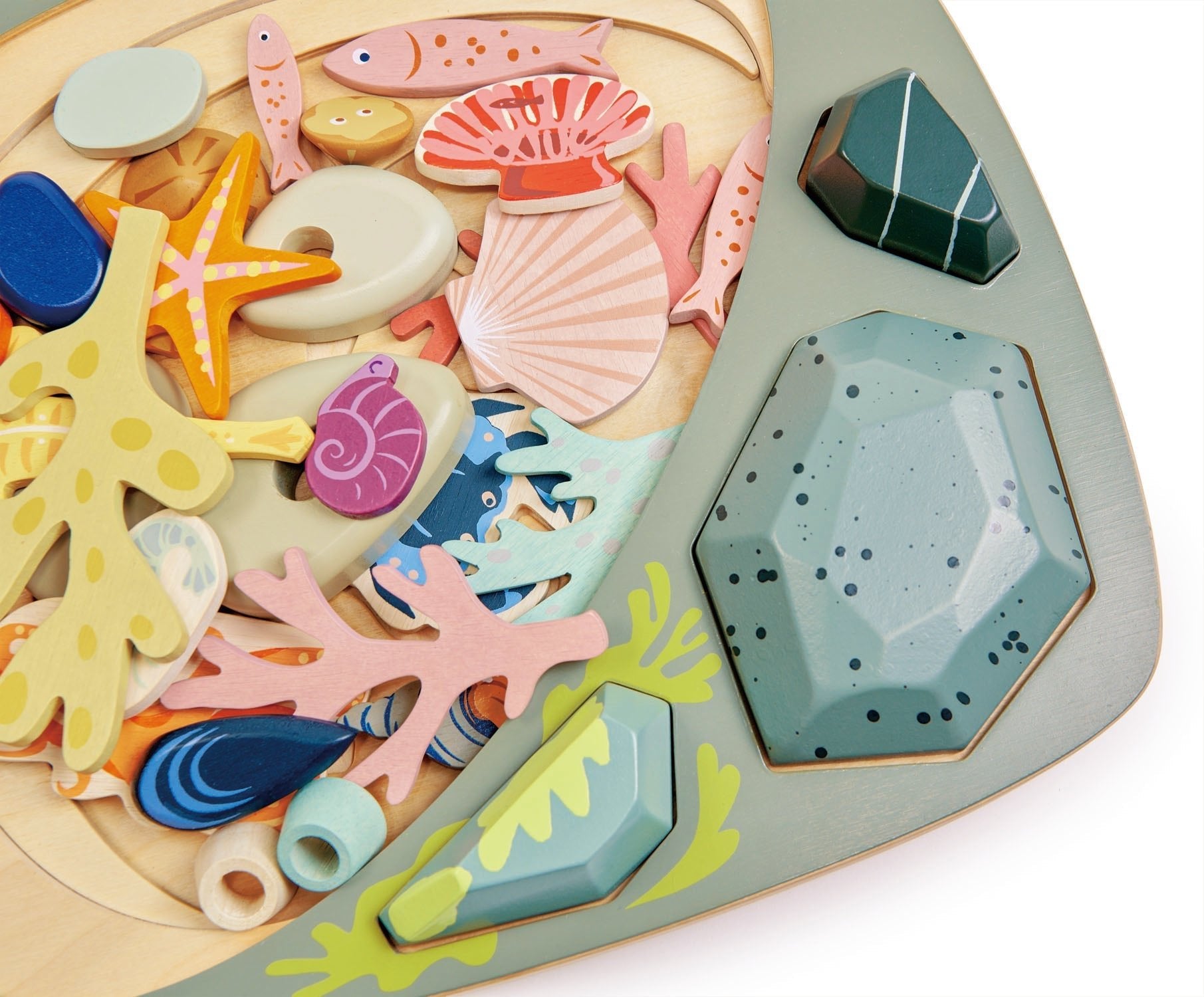 Colorful sea-themed wooden puzzle pieces on a white background