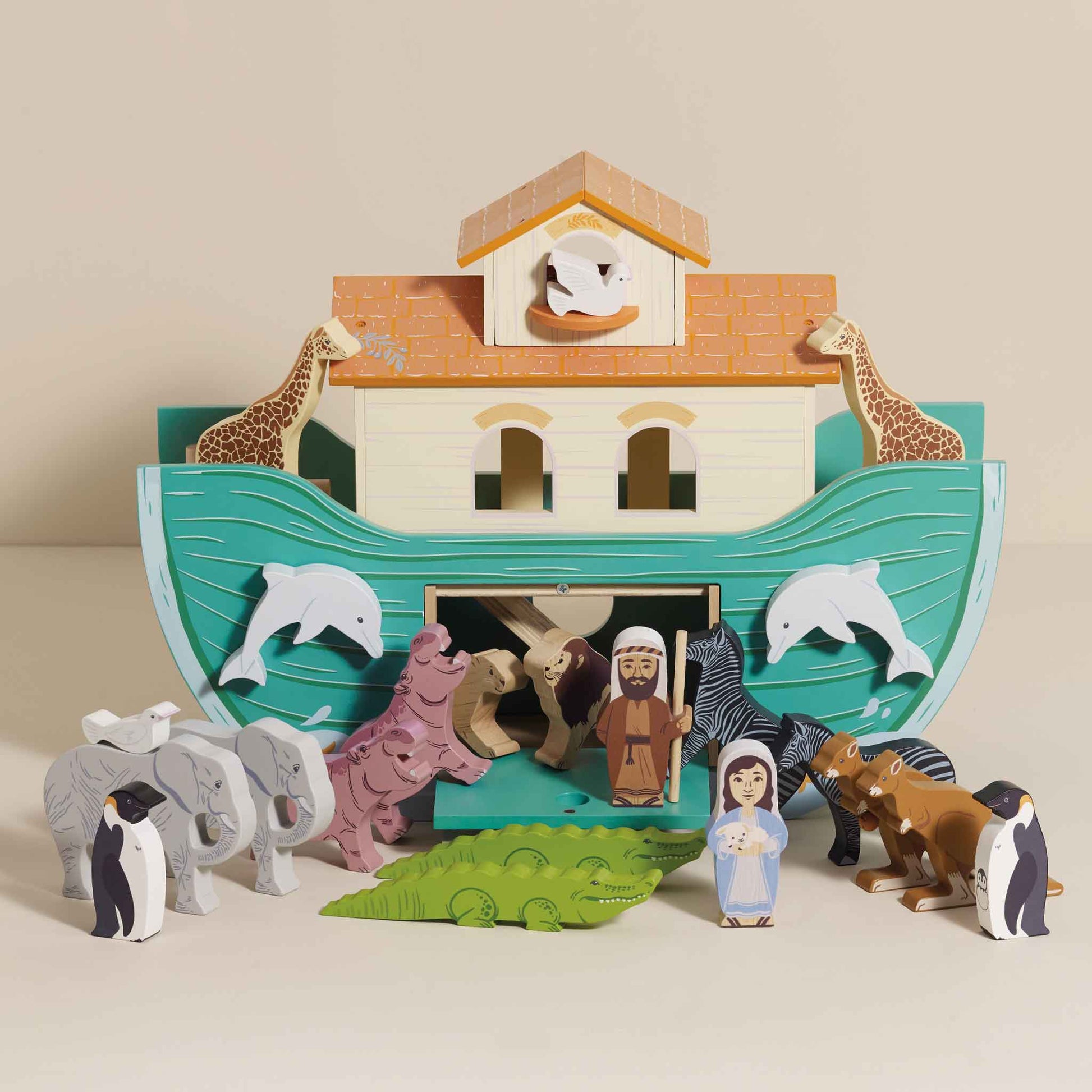 Wooden toy Noah's Ark with animals and figures on a beige background