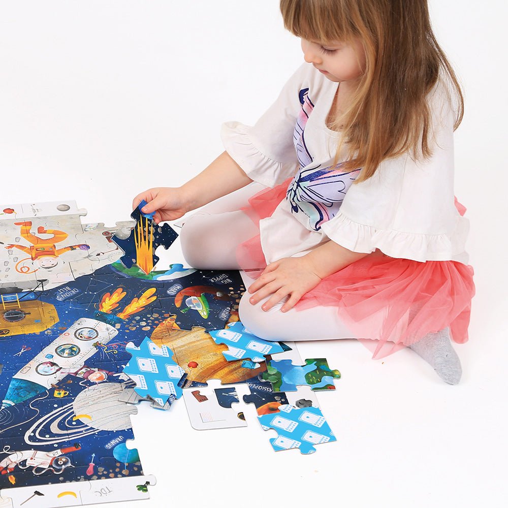 Child playing with a puzzle on a white floor
