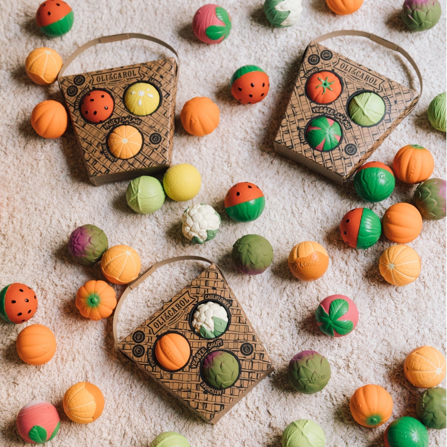 Colorful fruit-shaped candies with wooden boxes on a textured surface