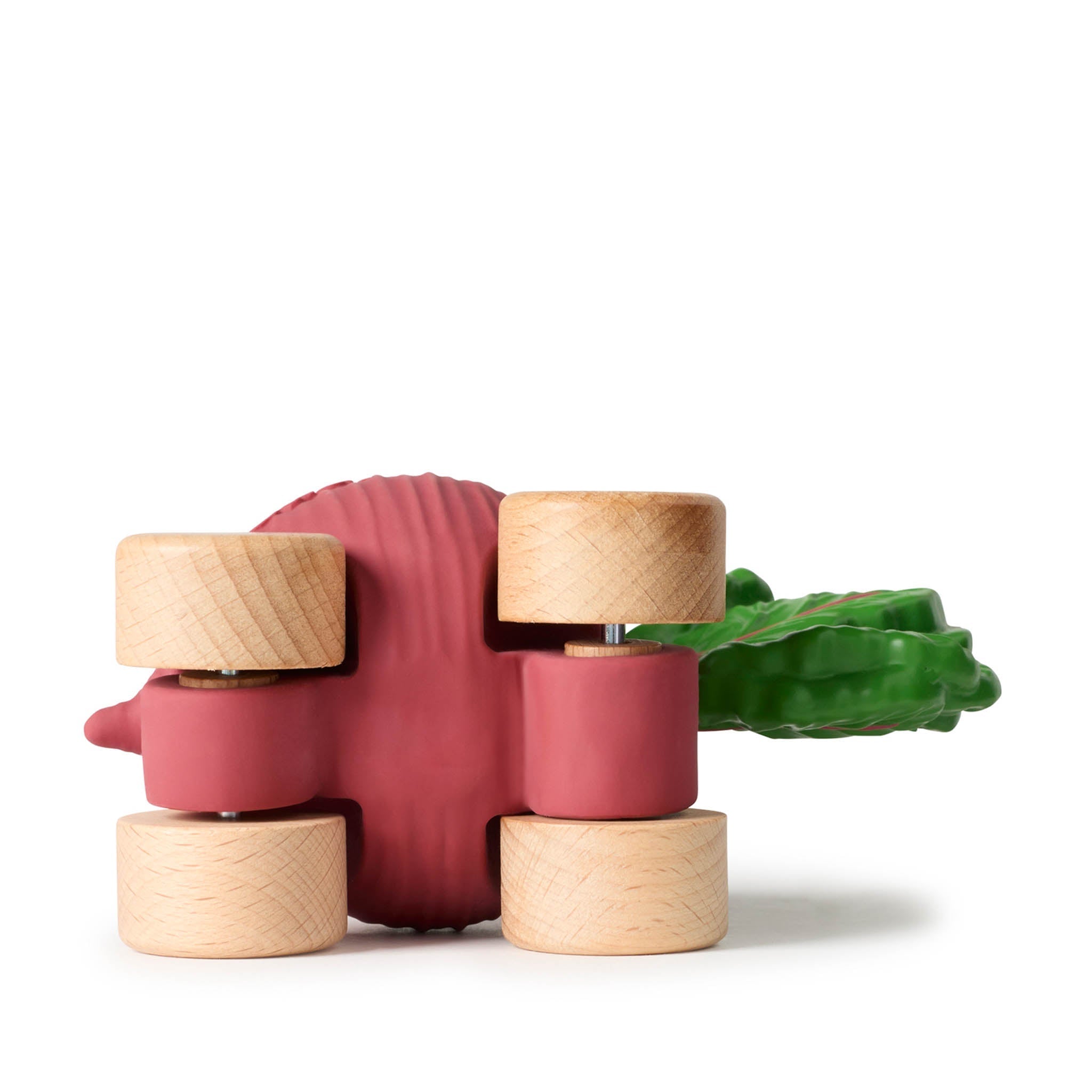 Red and wooden toy with a green leaf on a white background