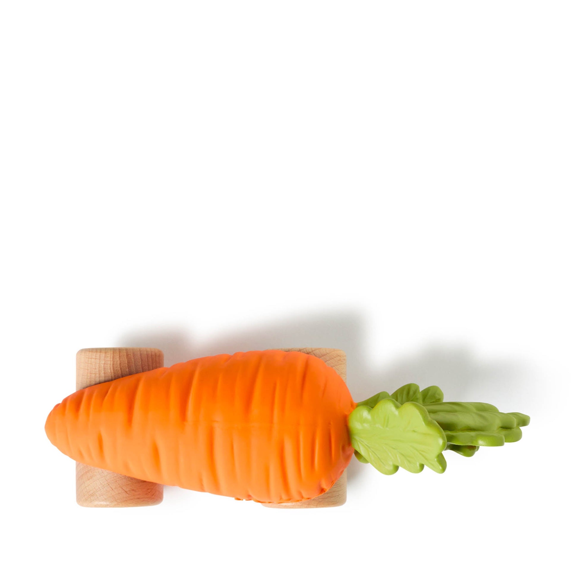 Carrot-shaped toy with wooden base on a white background