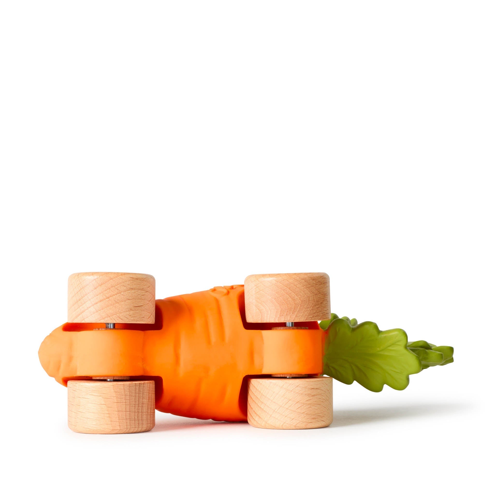 Toy carrot with wooden wheels on a white background
