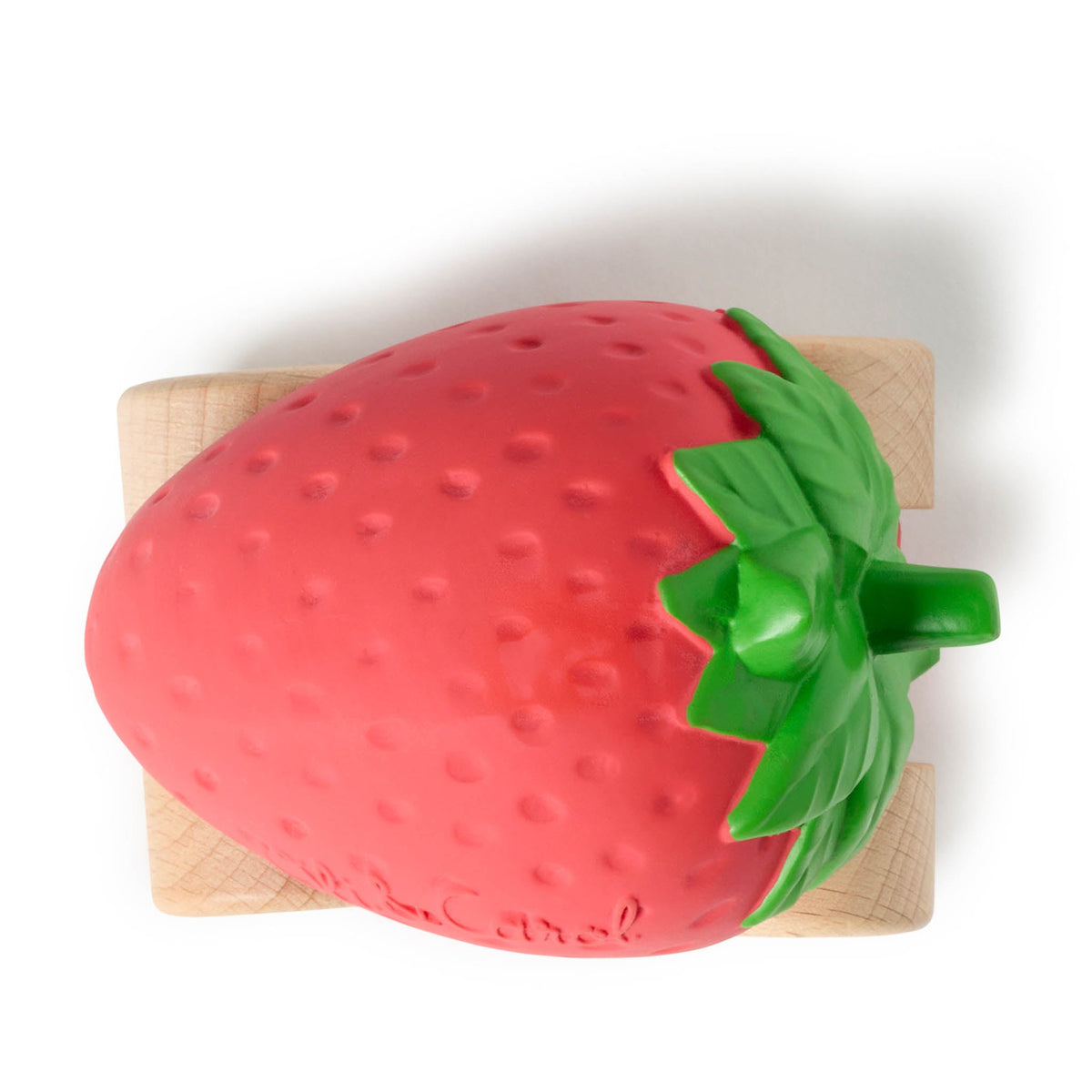 Strawberry-shaped object on a wooden cutting board with a white background