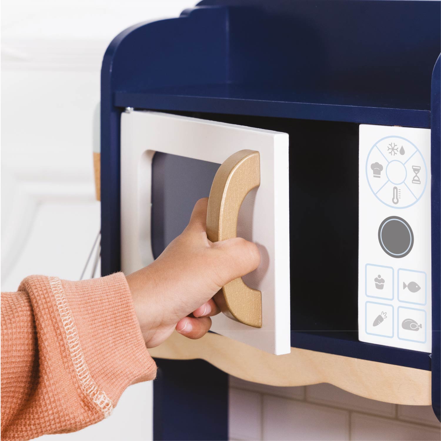 Hand opening a blue and white microwave oven door.