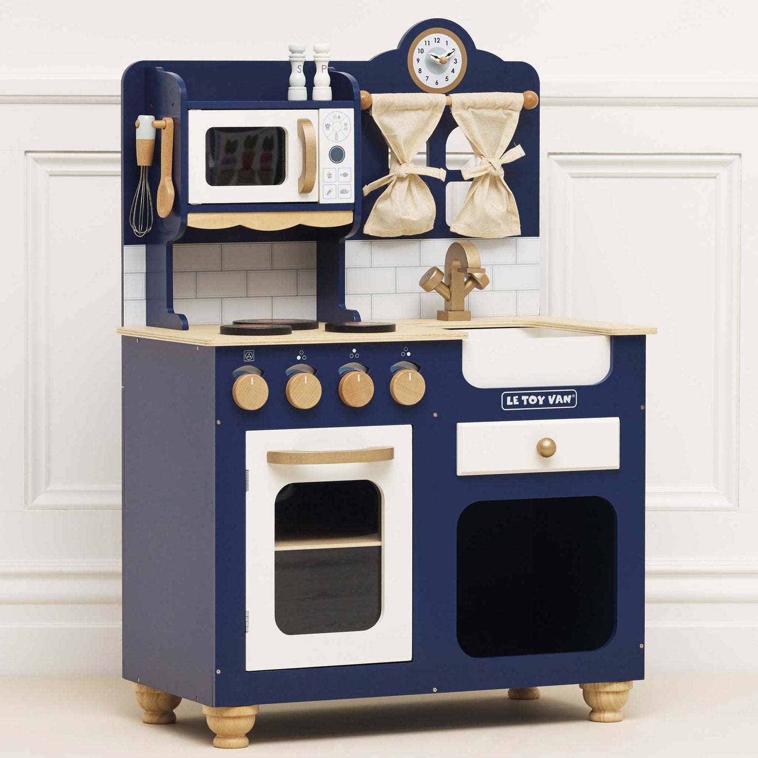 Children's wooden play kitchen set with blue and white design, featuring a clock and various utensils on a white background.
