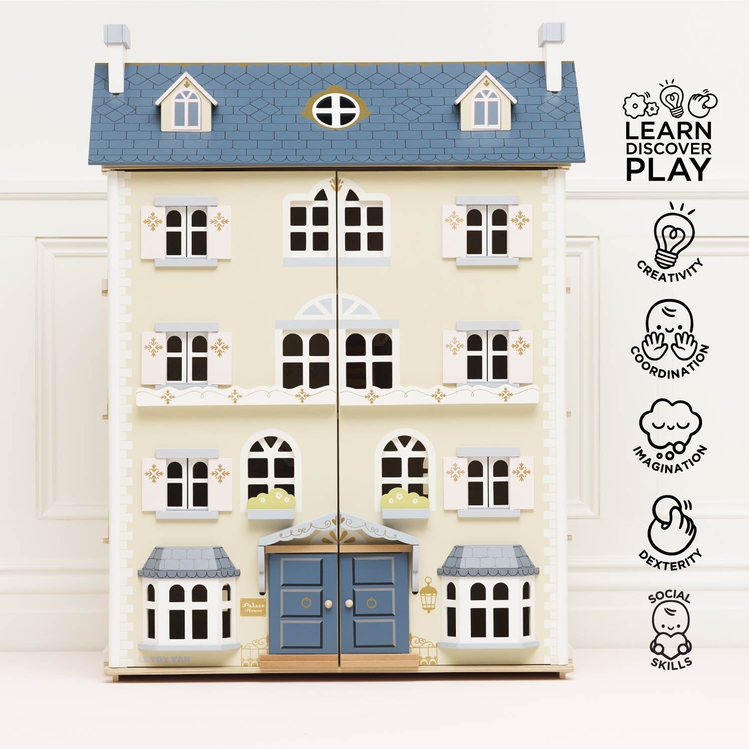 Toy dollhouse with blue roof and door on a white background, featuring educational icons.