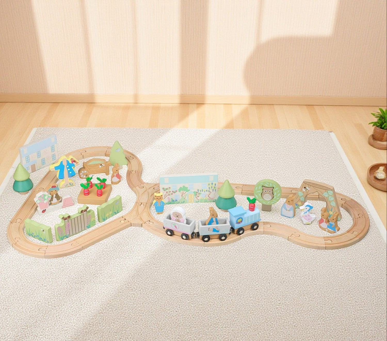 Wooden toy train set on a light-colored rug with a soft, warm background