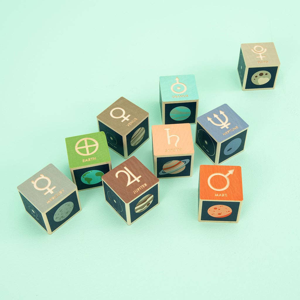 Set of astrological symbol-themed dice cubes on a light green background