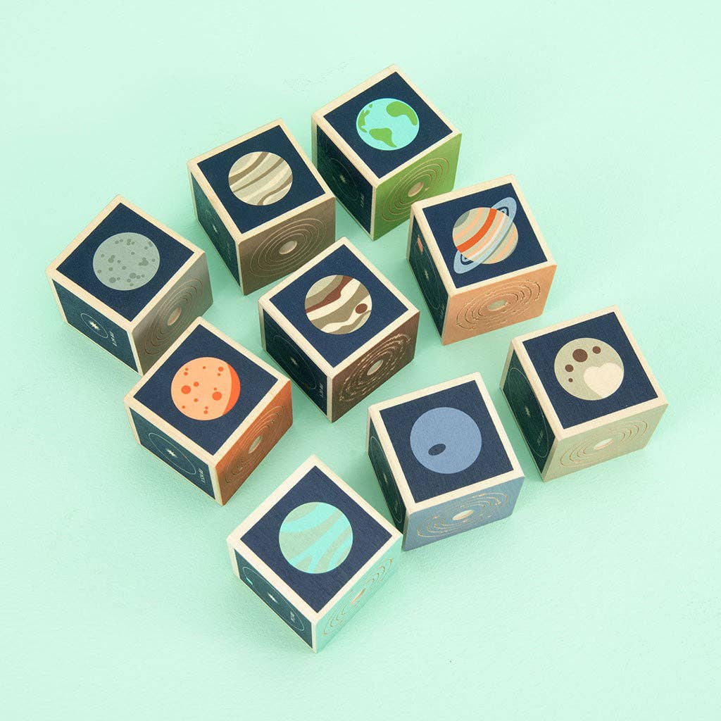Wooden blocks with planet illustrations on a light green background