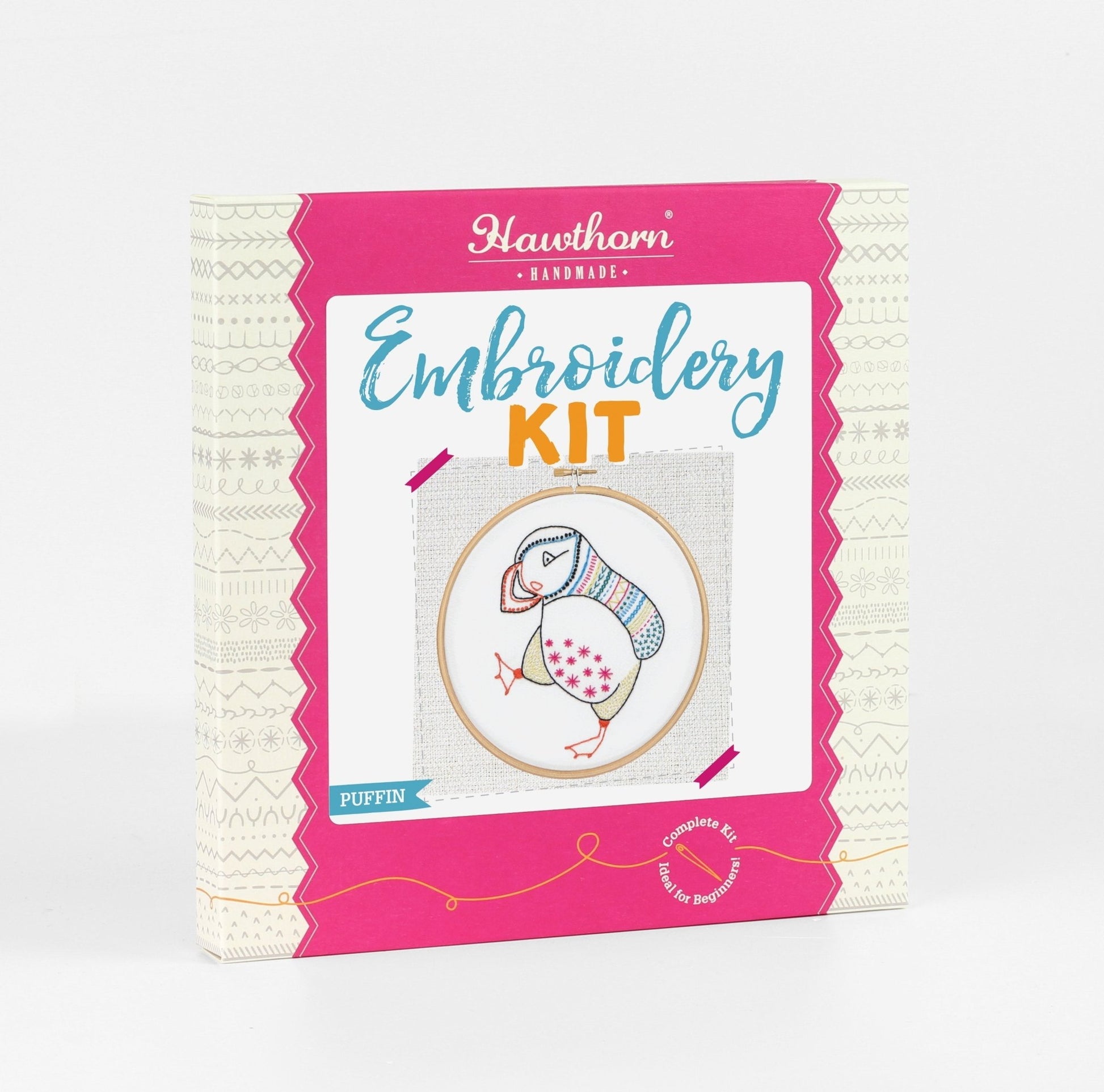 Embroidery kit packaging with a penguin design on a white background