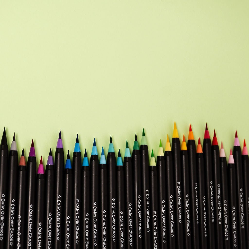 Set of colored pencils on a light green background