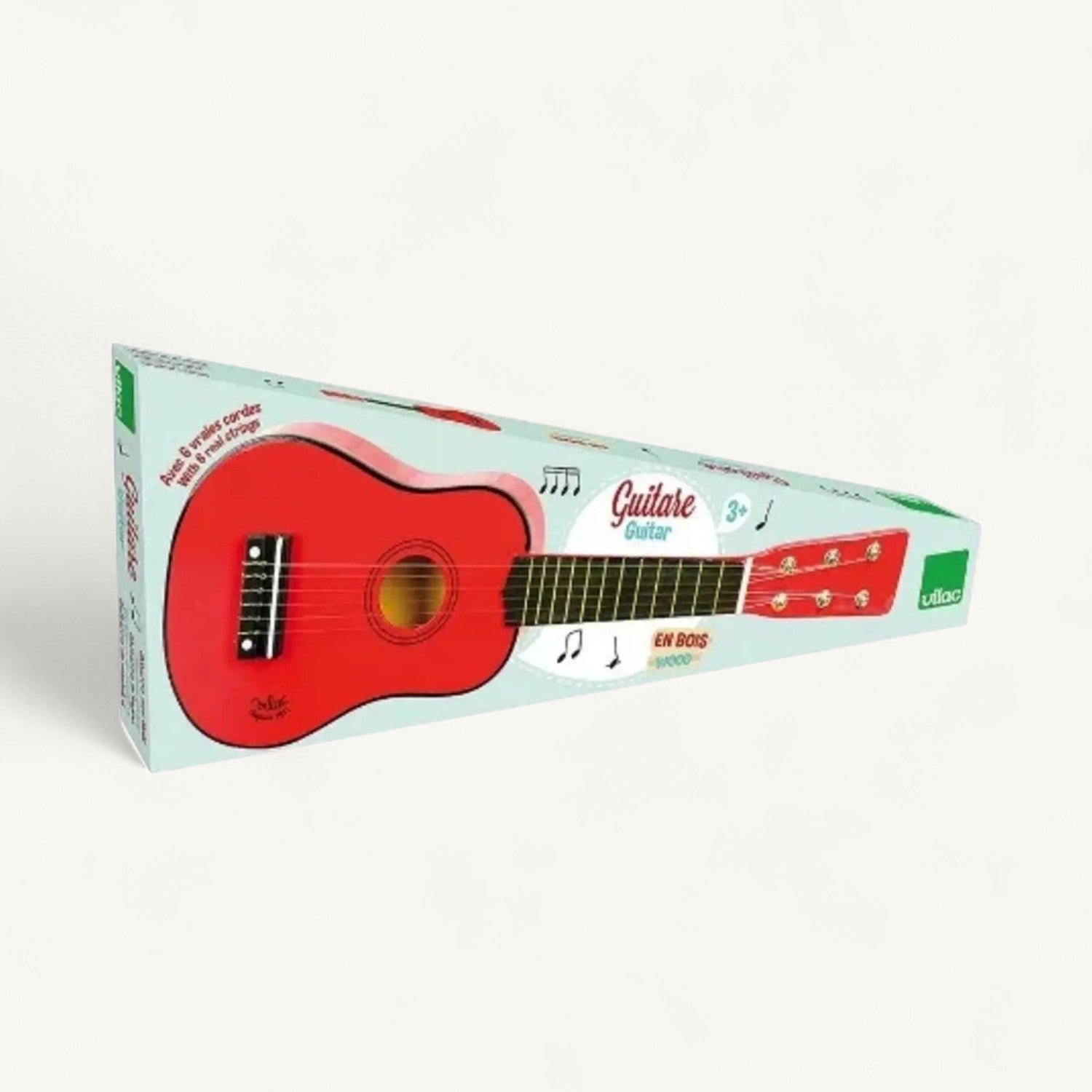 Red toy guitar with packaging on a white background