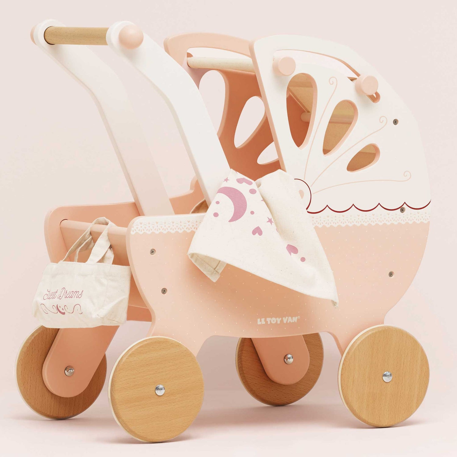 Pink and beige toy stroller with wooden wheels on a light pink background
