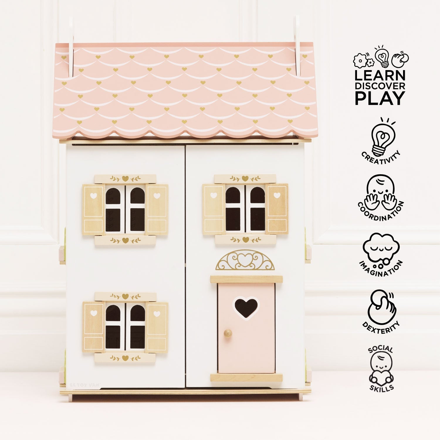 Wooden dollhouse with pink roof and windows on a white background, featuring 'Learn Discover Play' branding.