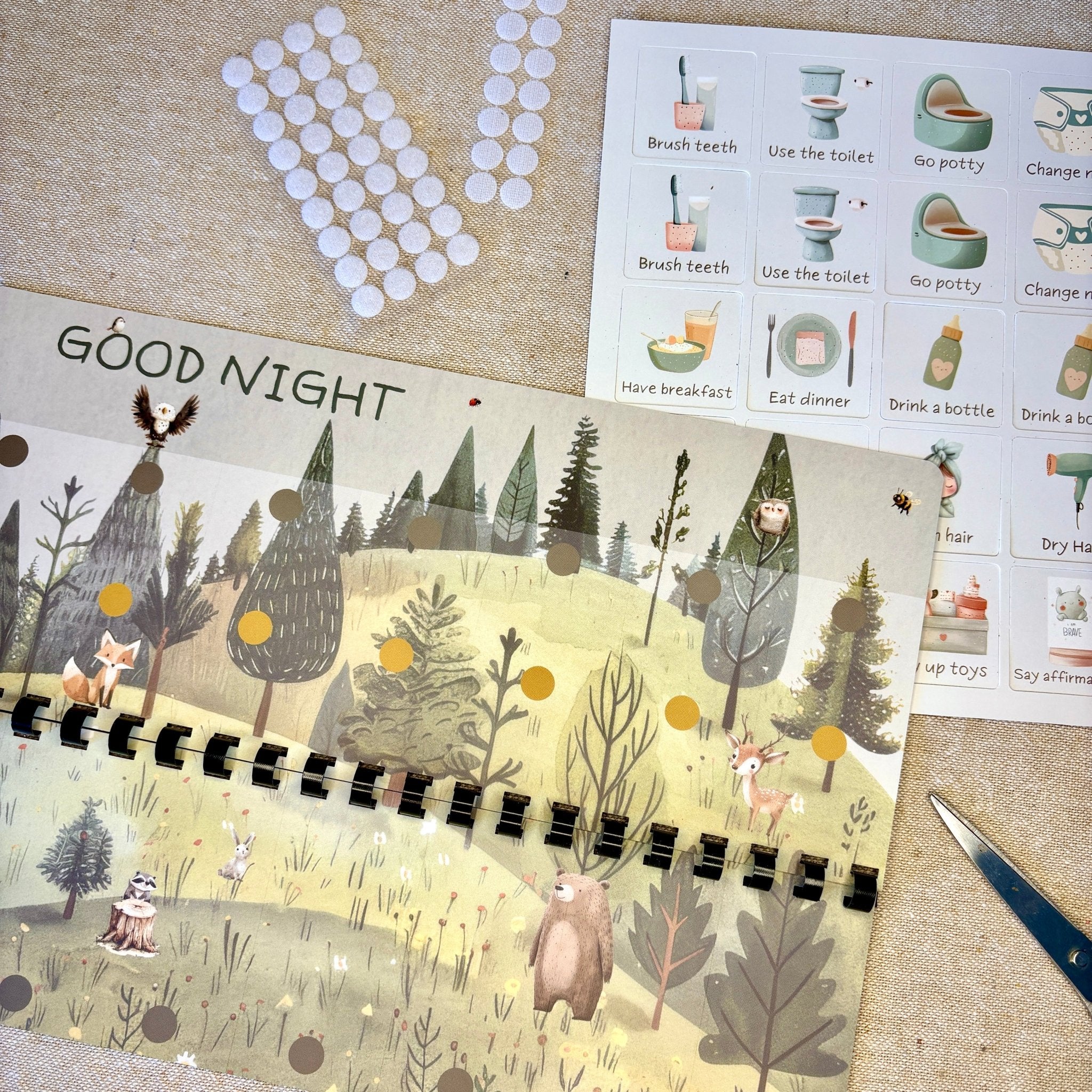 Children's book titled 'Good Night' with a forest illustration on a textured surface.