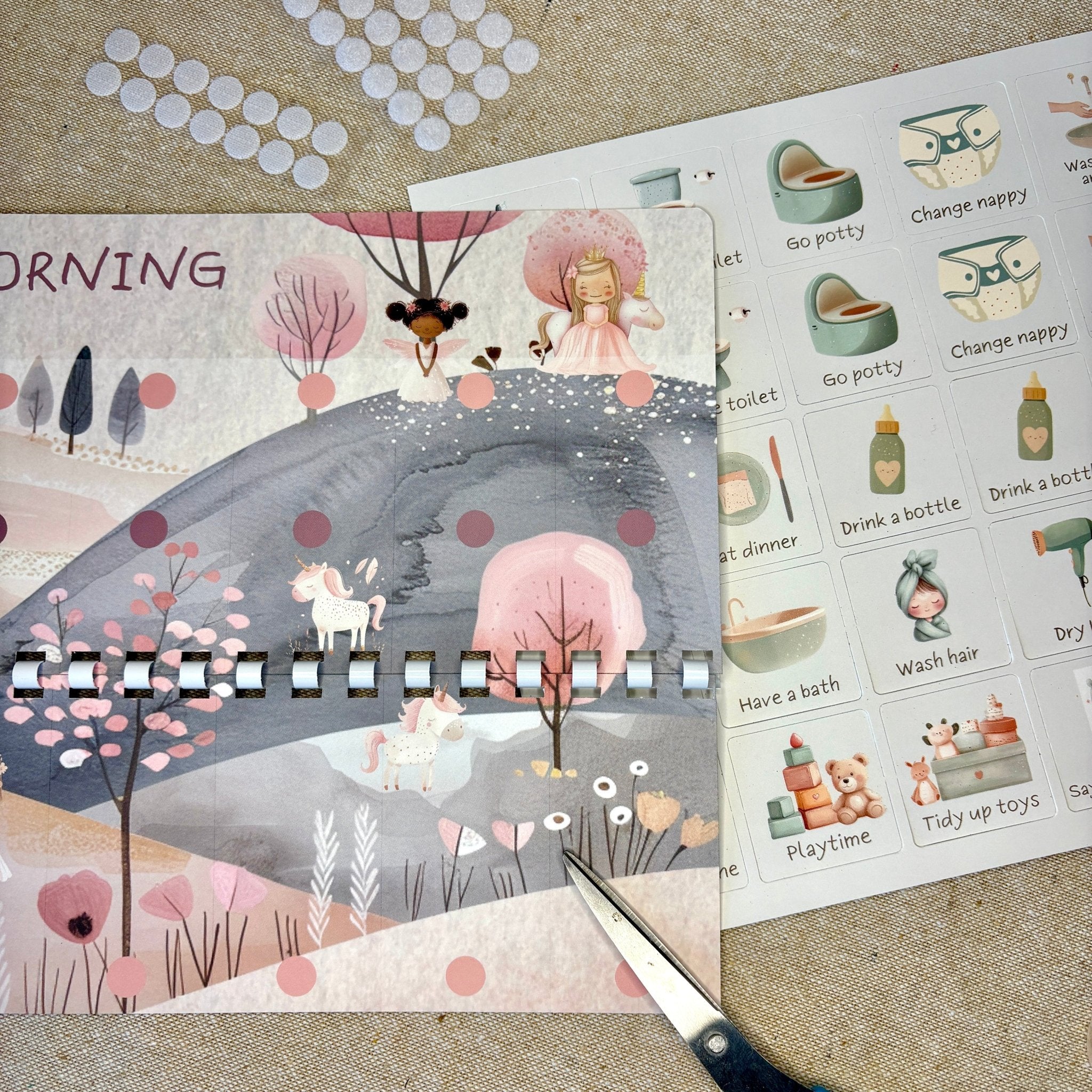 Children's activity book with illustrated pages and a set of stickers on a textured surface.