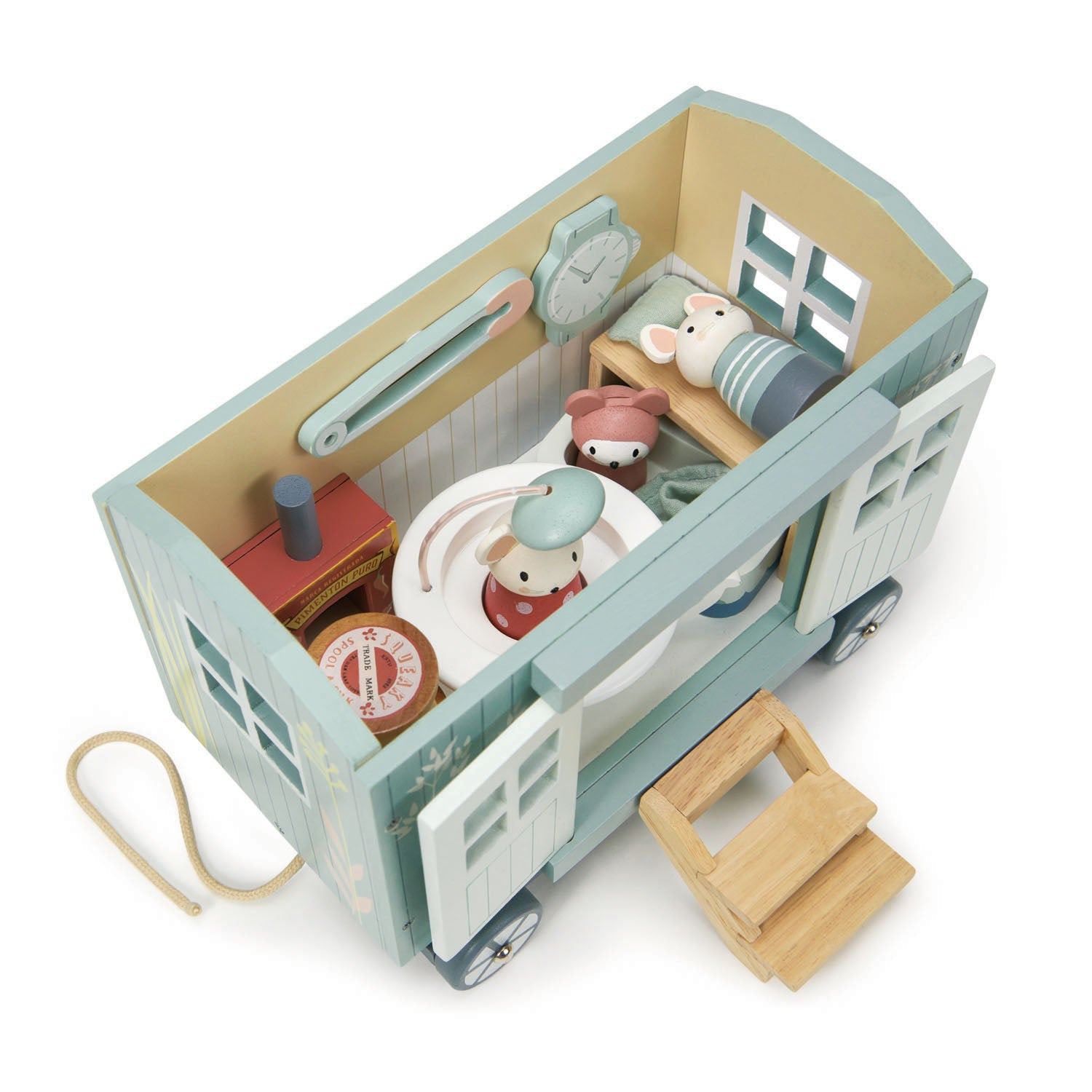Toy camper with interior details and small figures on a white background