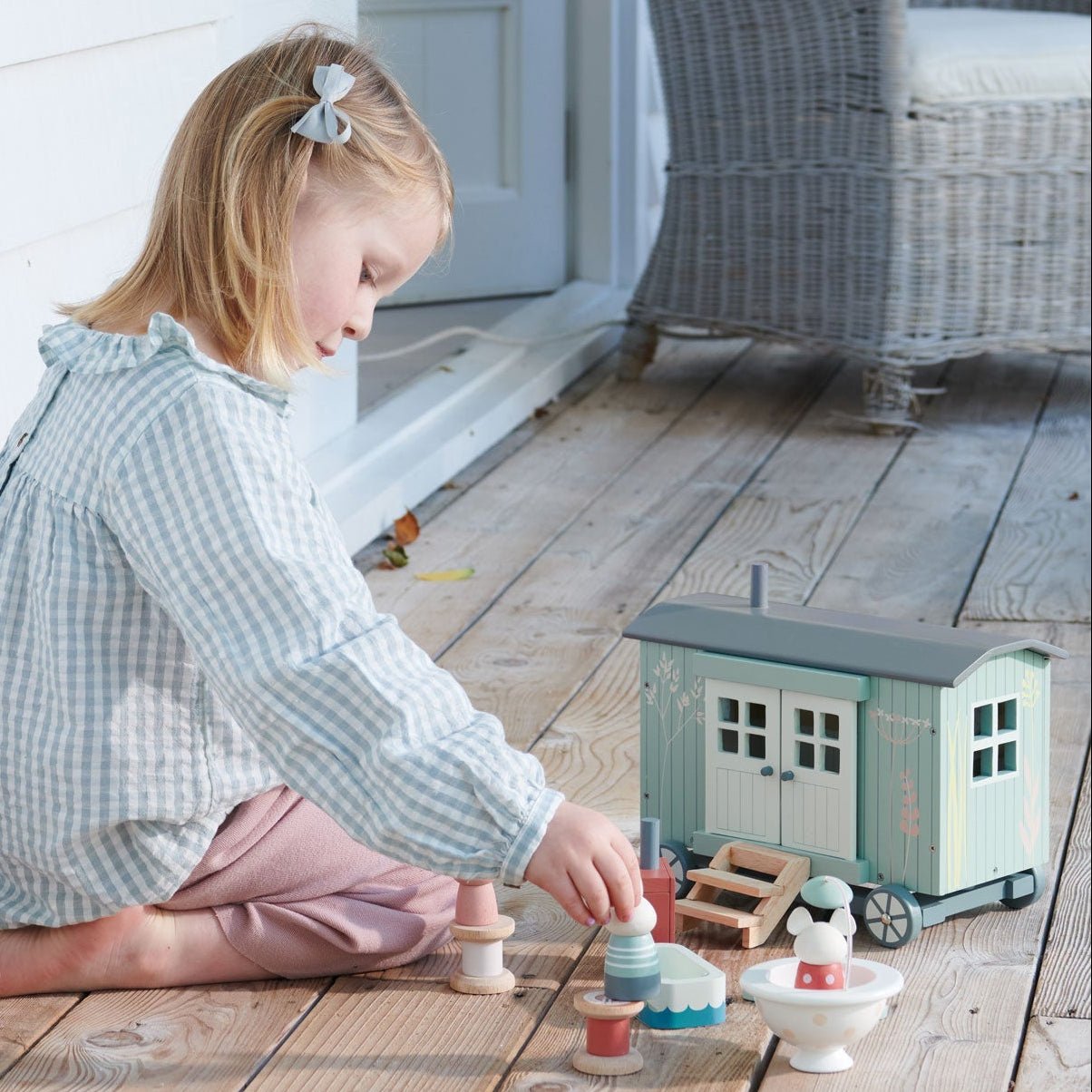 Child playing with wooden toys on a wooden floor