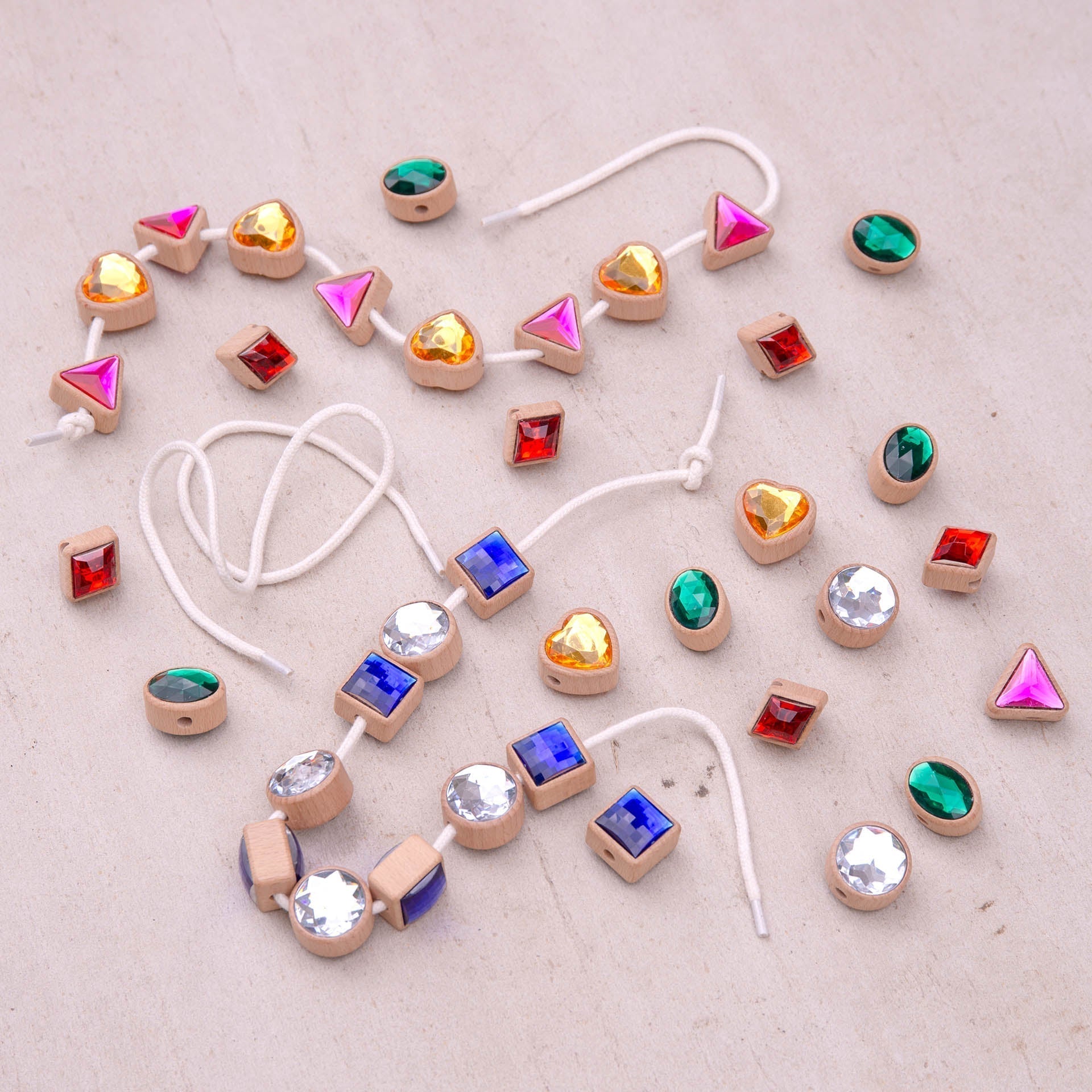 Colorful bead necklace with various shaped beads on a light background