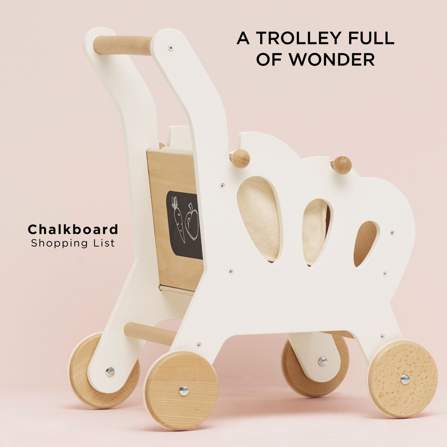 Children's wooden trolley with a chalkboard on a pink background