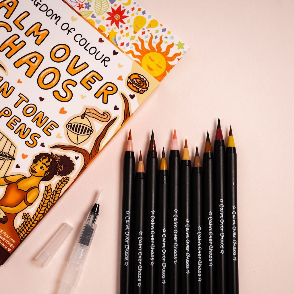 Set of Calm Over Chaos art supplies including pencils and a coloring book on a light pink background.